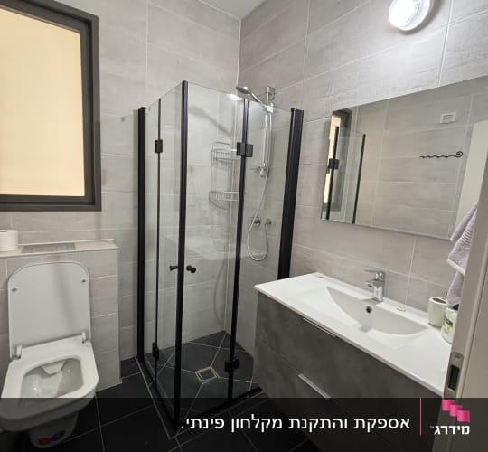 מקלחון פינתי מותקן עם פרופיל שחור בחדר רחצה מודרני